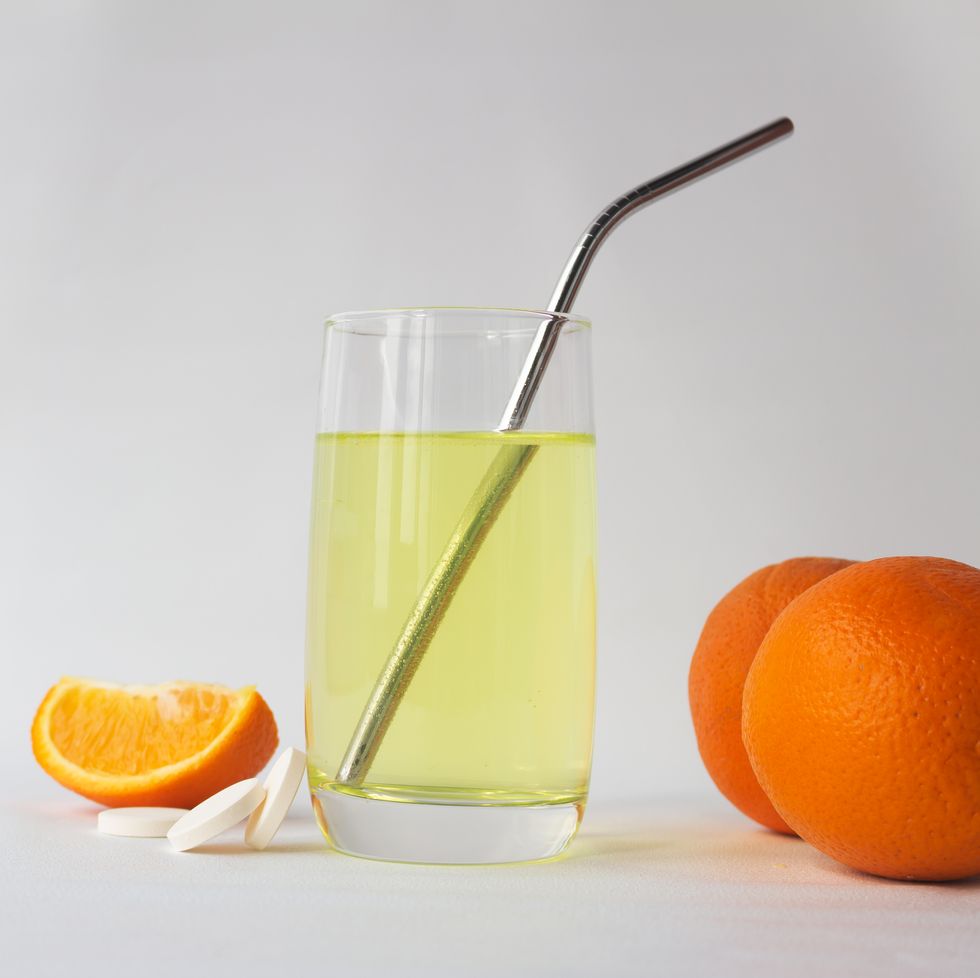 vitamin c soluble effervescent tablets in a glass of water with a stainless straw orange he drink enhances immunity and resistance to viruses