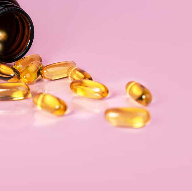 vitamin d bottle with capsules on yellow background omega 3