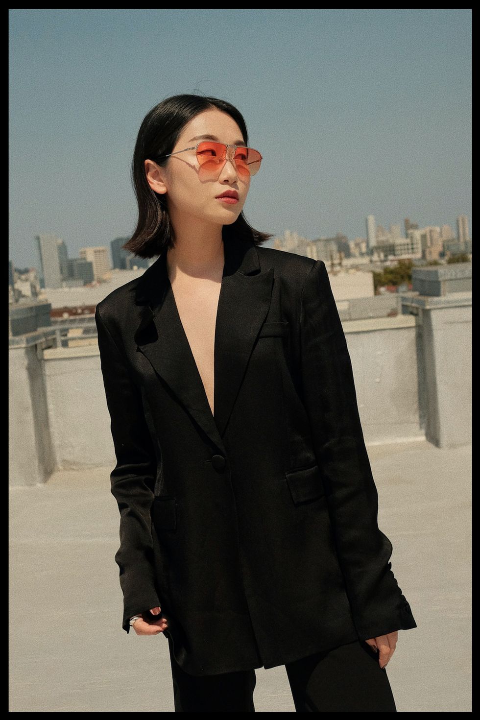 stylist vivid wu stands on a rooftop to illustrate her fashion resolution for 2022