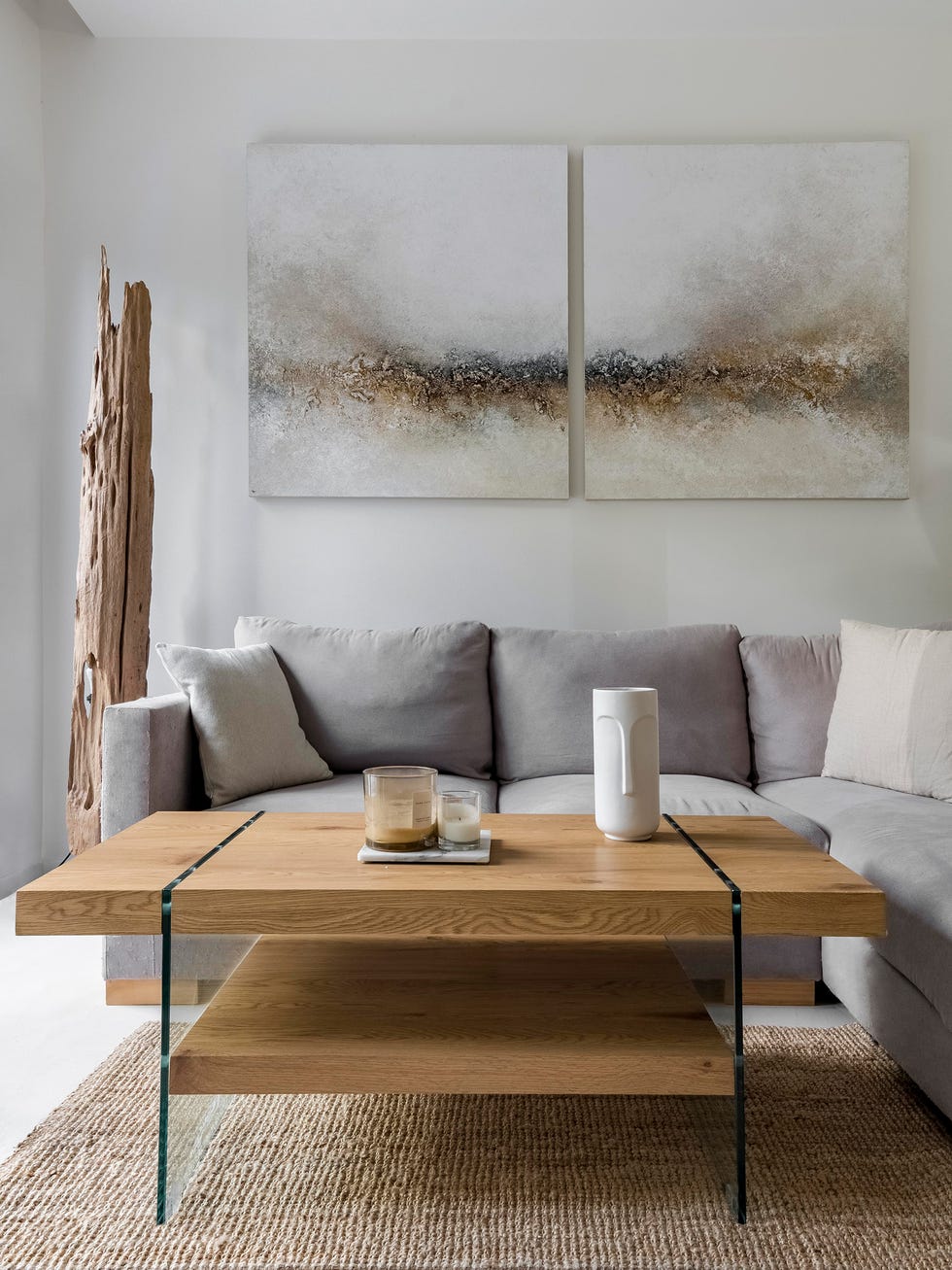sofá con chaiselongue gris y mesa de centro de madera sobre alfombra de yute