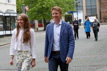 a man and woman walking on a street