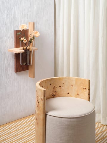 wooden chair and wooden test tube vase on wall