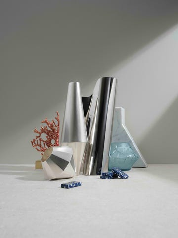 an assortment of silver and ceramic vases