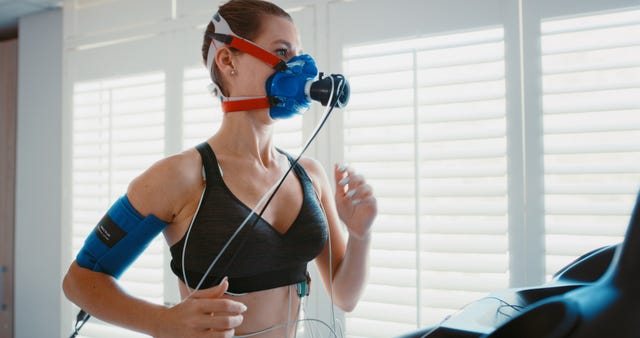 vo2 max training mask with a young athlete exercising for fitness during a workout at the physio to monitor her health and wellness cardio, endurance and running for medical testing and insurance