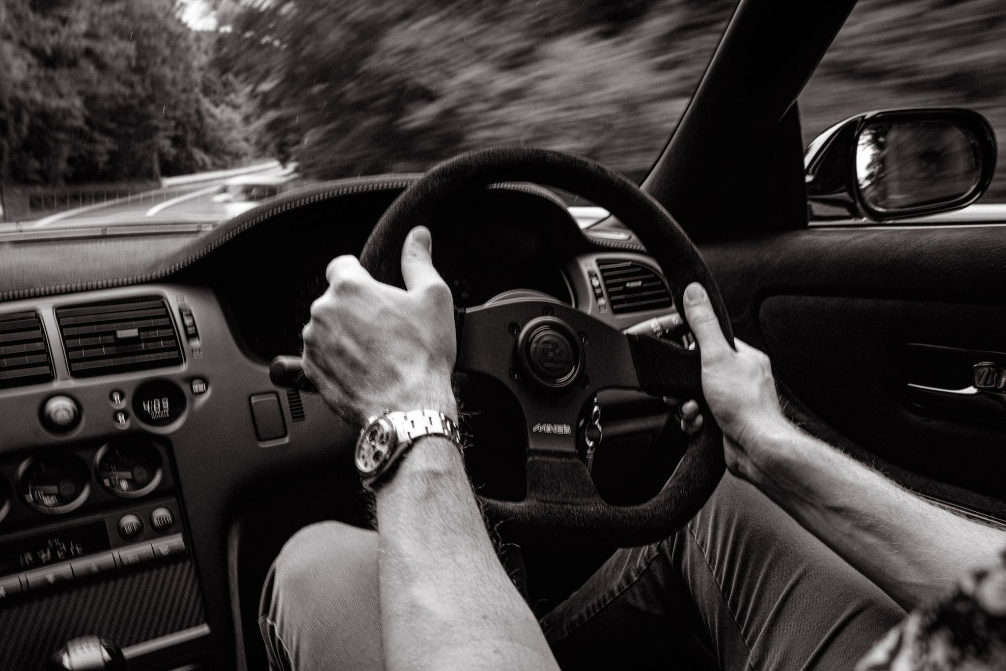 a person holding a steering wheel