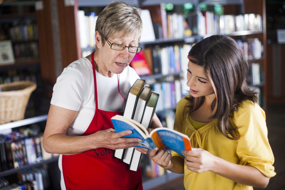 Volunteer Librarian Helping Student