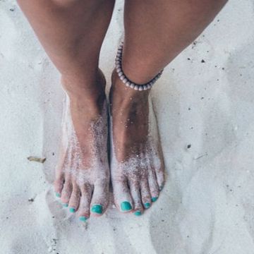 Vrouw met voeten in het zand