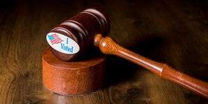 i voted campaign button or sticker with a gavel and mallet to illustrate lawsuits about voting