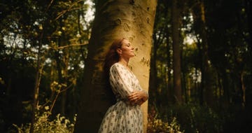 princess kate leans against a tree