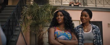 sza and keke palmer are positioned in front of a multi story building