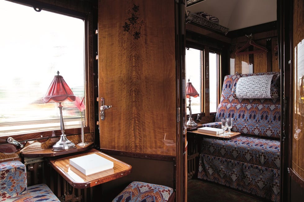 luxurious train compartment interior with wooden paneling and elegant furnishings