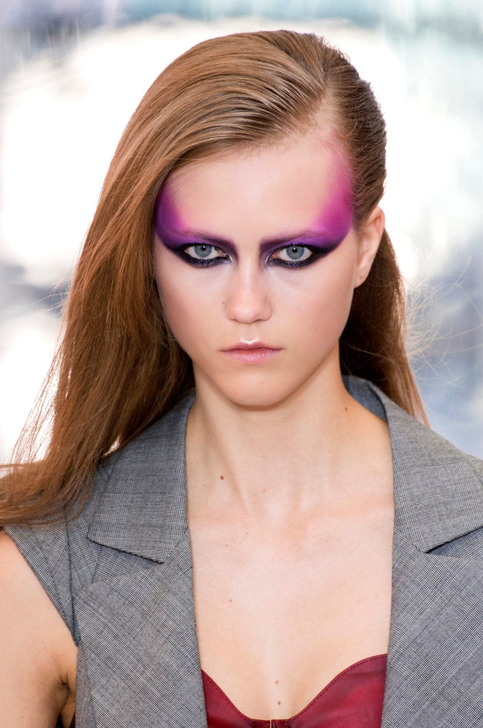Person in a stylish outfit with long hair