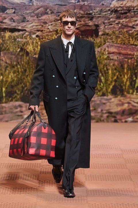 a man in a suit carrying a suitcase