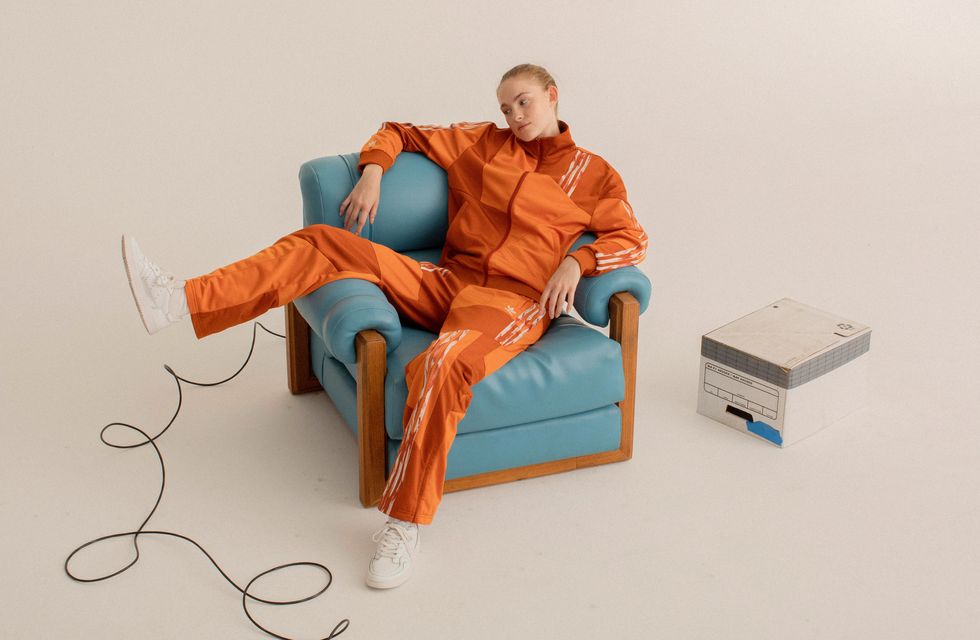 Sitting, Orange, Furniture, Joint, Couch, Stock photography, Comfort, Action figure, Fictional character, Art, 