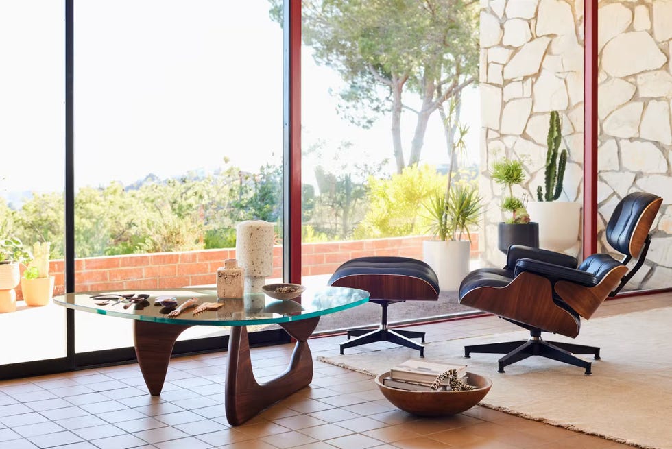 a room with a table chairs and a window with a view of a city