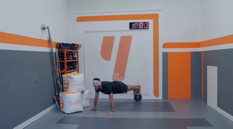 a person doing a back bend on a mat in a room