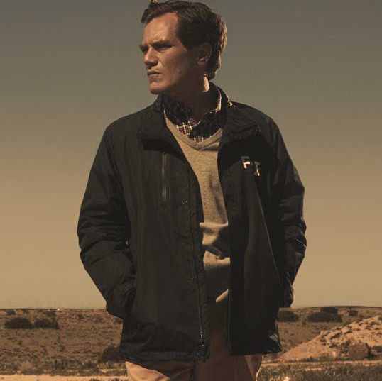 michael shannon in a still from 'waco' he is standing in a deserted landscape presumably, what is meant to be waco, texas, staring into the distance on his right