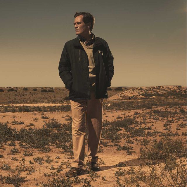 michael shannon in a still from 'waco' he is standing in a deserted landscape presumably, what is meant to be waco, texas, staring into the distance on his right