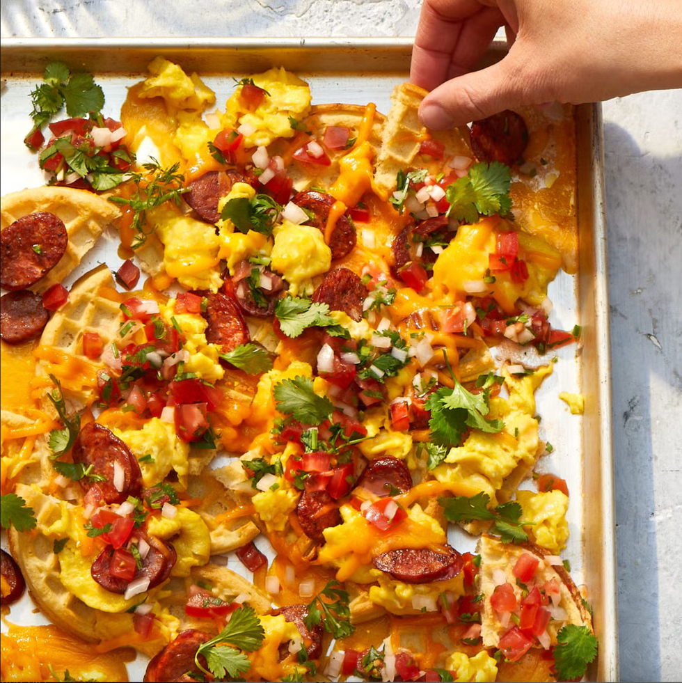 waffle nachos loaded with eggs, chorizo, cheese, and pico de gallo all on a sheet pan