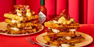 waffles with spicy glazed bacon and pecans against red curtain