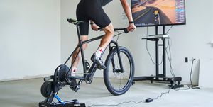 a person riding a mountain bike on an indoor trainer
