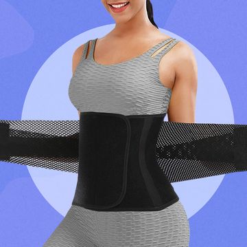 woman putting waist trainer on over athletic clothes
