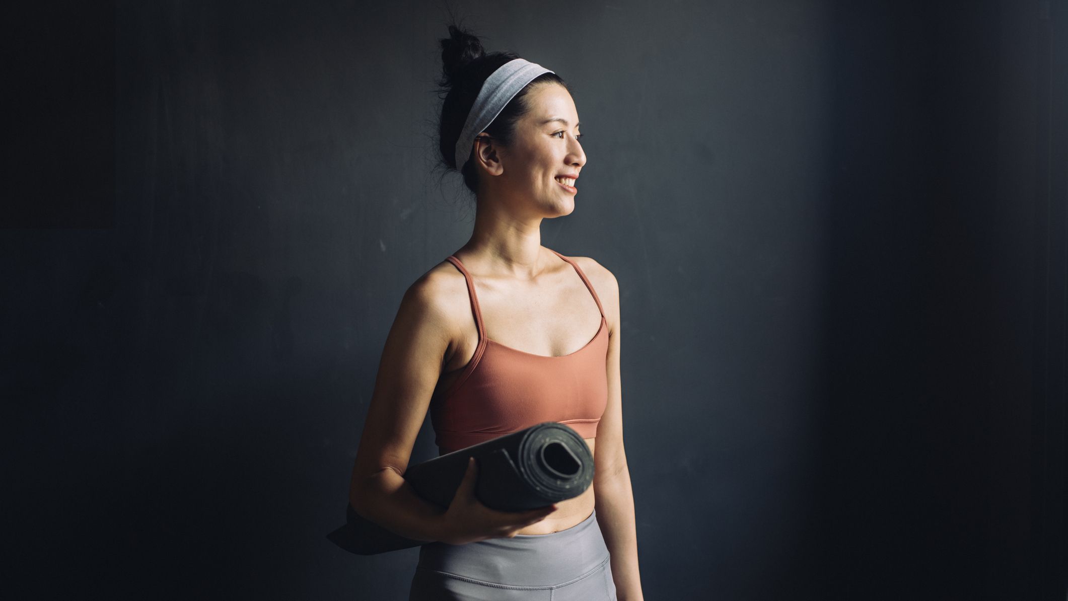 https://hips.hearstapps.com/hmg-prod/images/waist-up-portrait-of-a-happy-asian-woman-in-sports-royalty-free-image-1591304235.jpg?crop=1xw:0.84415xh;center,top