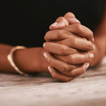 woman's hands clasped together in prayer