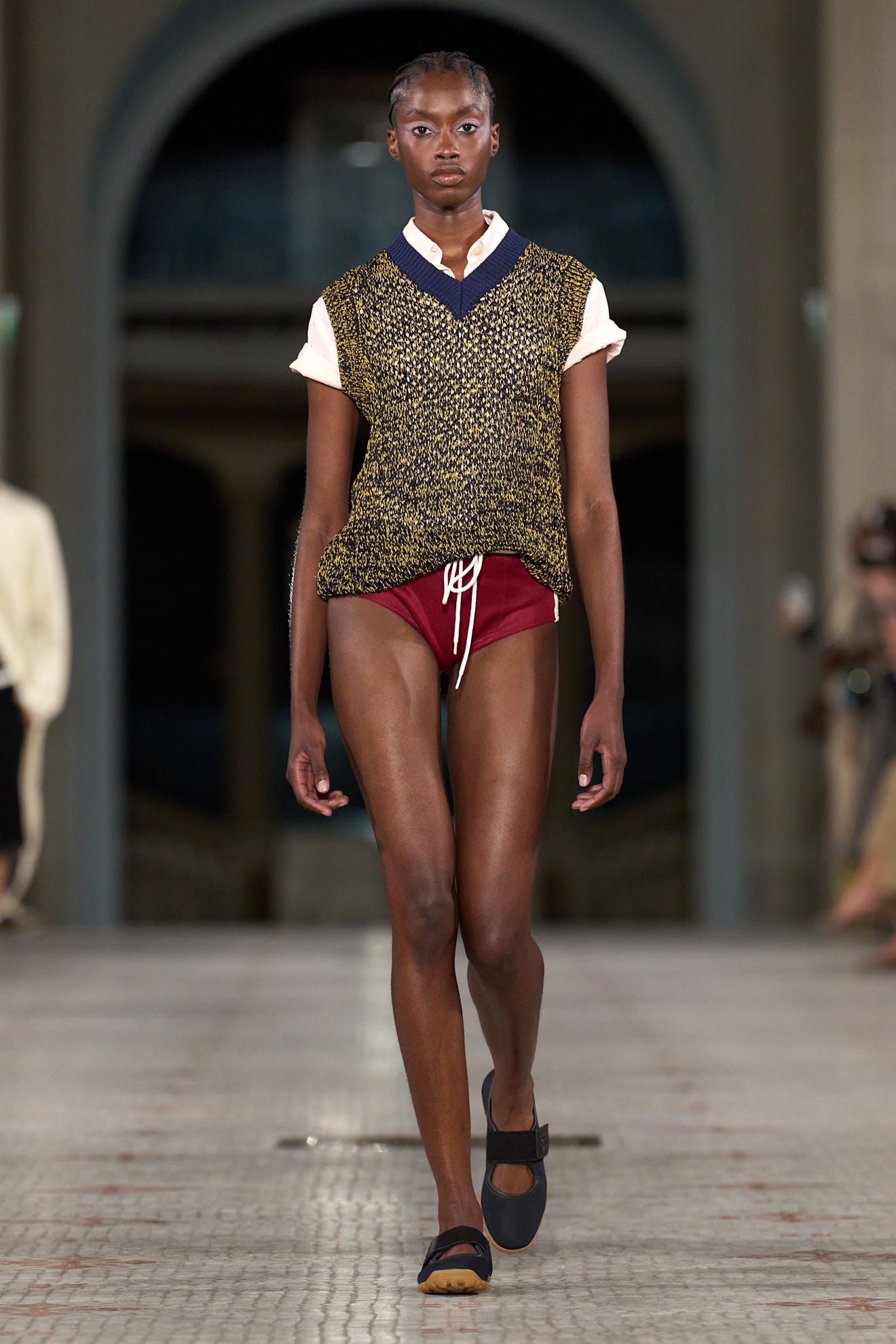 A model walks the runway wearing a unique outfit