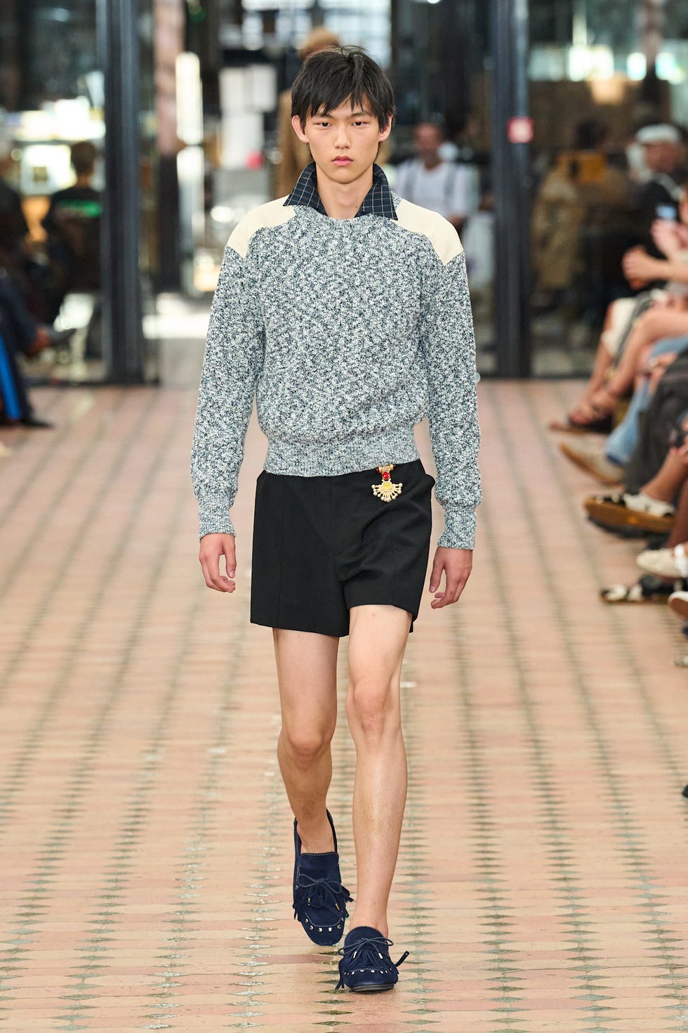 Male model showcasing a fashion outfit on a runway