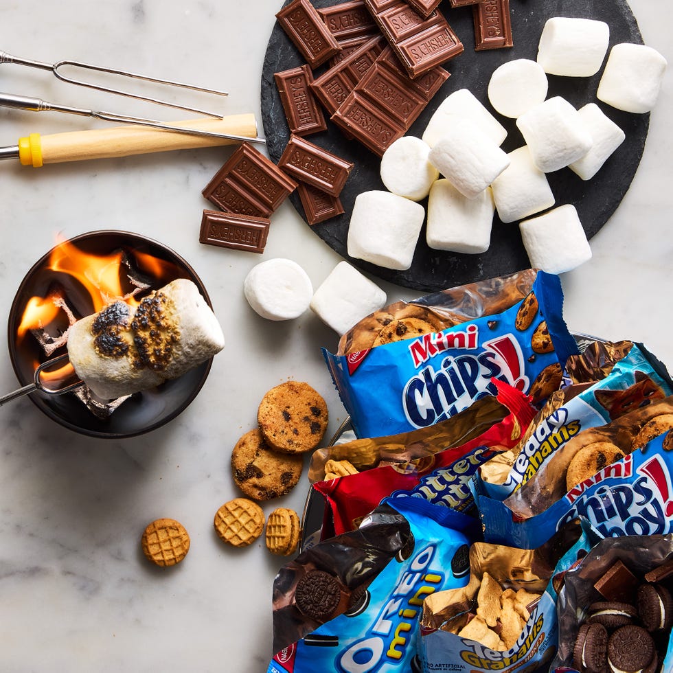 bags of oreos, chocolate chip cookies, and teddy grahams filled with toasted marshmallows and chocolate