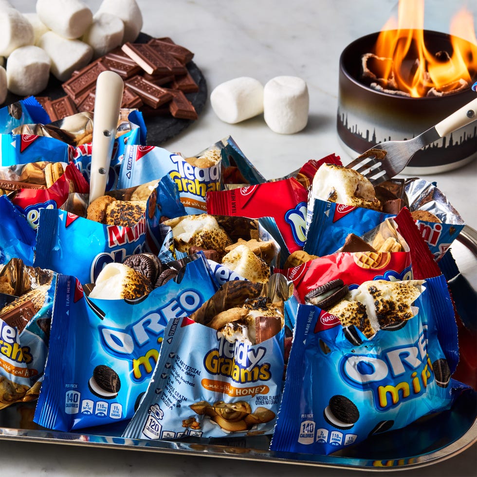 bags of oreos, chocolate chip cookies, and teddy grahams filled with toasted marshmallows and chocolate