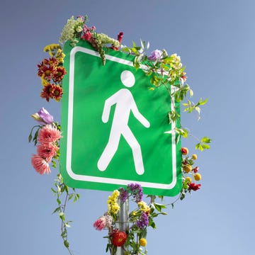 walking sign covered with flowers