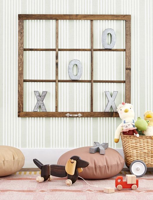 an old window with no glass becomes a tic tac toe game when hung on a wall