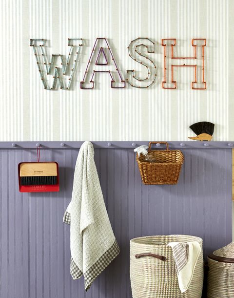 the word wash is spelled out with nails and string in a laundry room