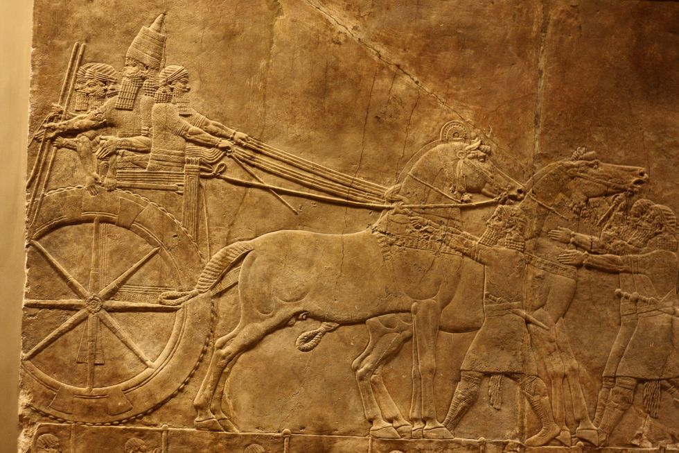 wall panel depicting the royal lion hunt grooms lead horses towards an enclosure assyrian, circa 645 635 bc from the north palace in nineveh