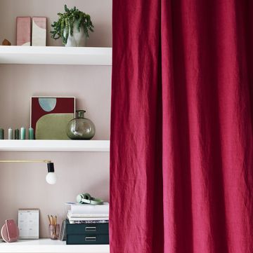 floating wall shelves covered with a pink linen curtain