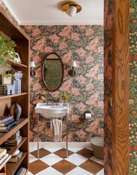 small bathroom with wallpaper behind secret door