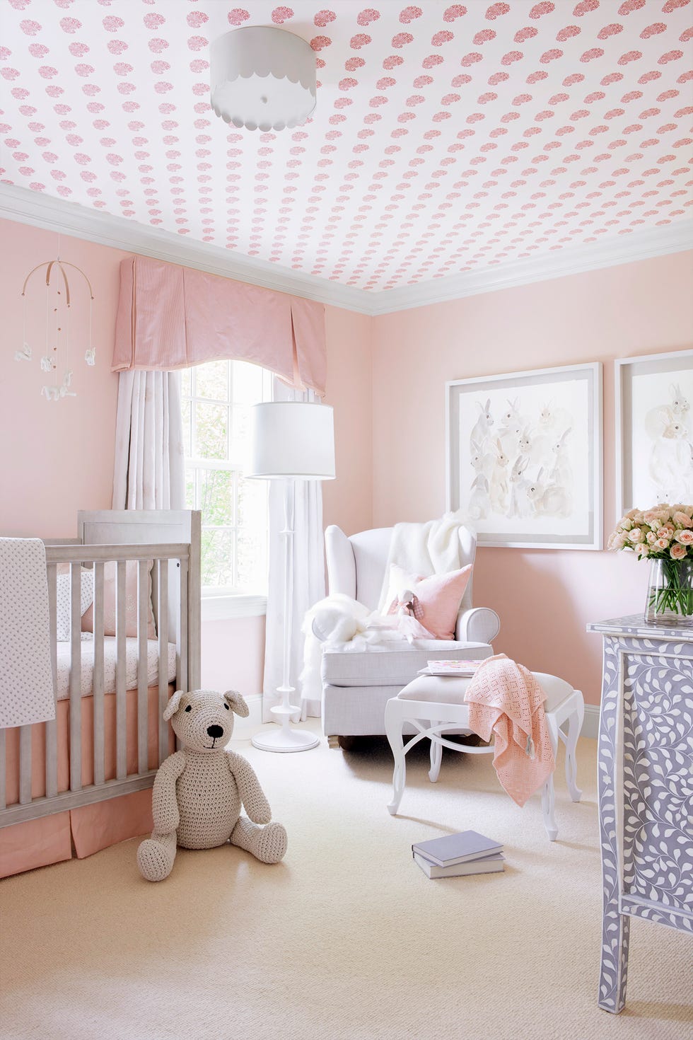 nursery room with wallpaper on ceiling