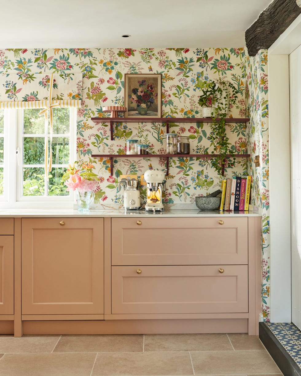 a kitchen with a window and woodland floral wallpaper