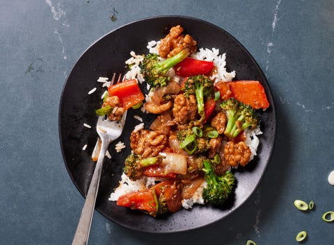 Walnut & Broccoli Stir-Fry - Delish.com walnut broccoli stirfry on white rice with red bell peppers and glazy sauce