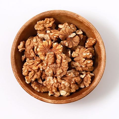 Directly Above Shot Of Walnuts In Bowl Against White Background