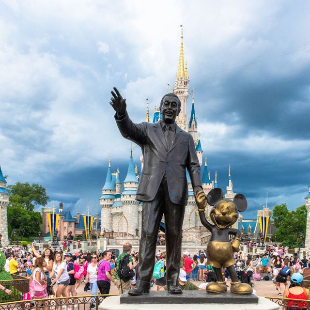 walt disney and mickey mouse statue inside of the magic