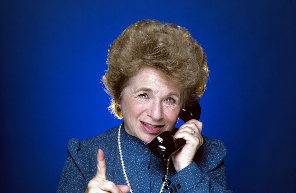 dr ruth westheimer holding a phone to her ear in 1984