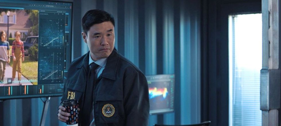 randall park as jimmy woo dressed in an fbi jacket and holding a cup of coffee in wandavision episode 5 screengrab