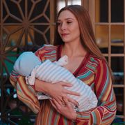 elizabeth olsen as wanda maximoff, holding her baby, in wandavision