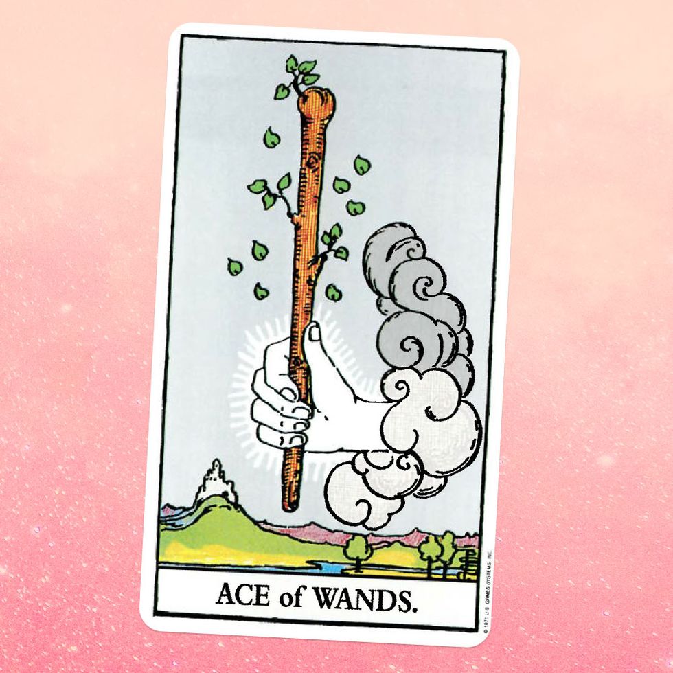 the tarot card the ace of wands, showing a white hand coming out of a cloud, holding a  giant wooden wand