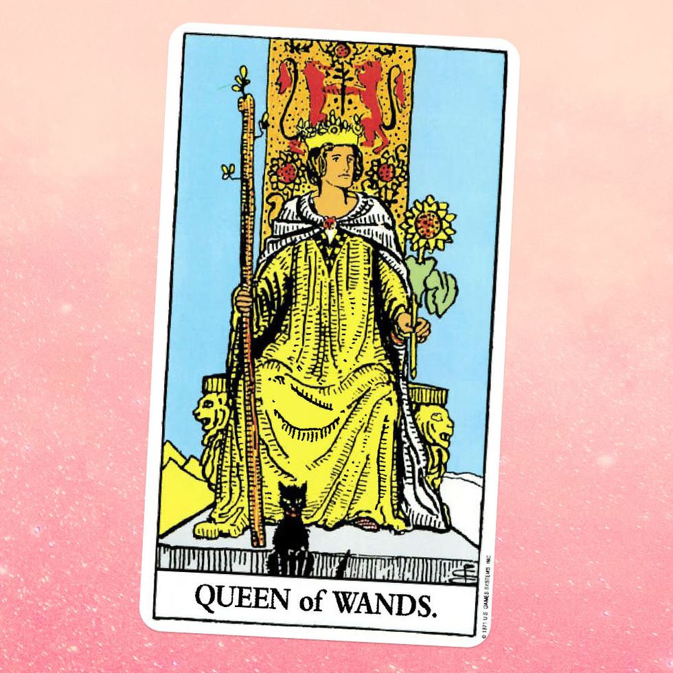 the queen of wands tarot card, showing a white woman in a yellow gown and white cape sitting on a throne, holding a wooden staff