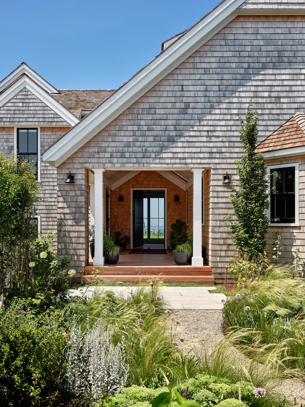 entrance of a house surrounded by lush greenery and plants