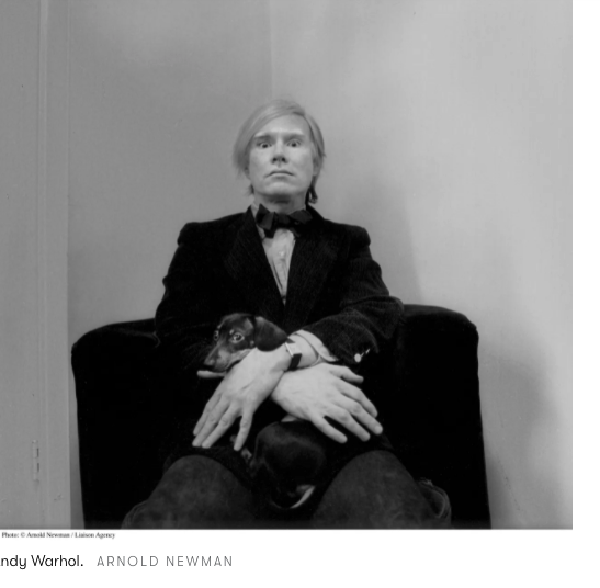 andy warhol in the cartier tank watch posing with a dog on his lap